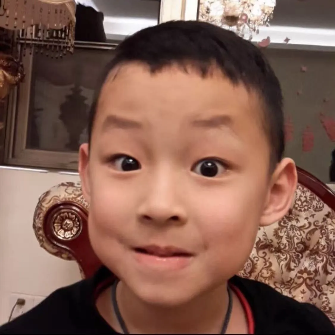 Noah Xu as a child, making a playful expression