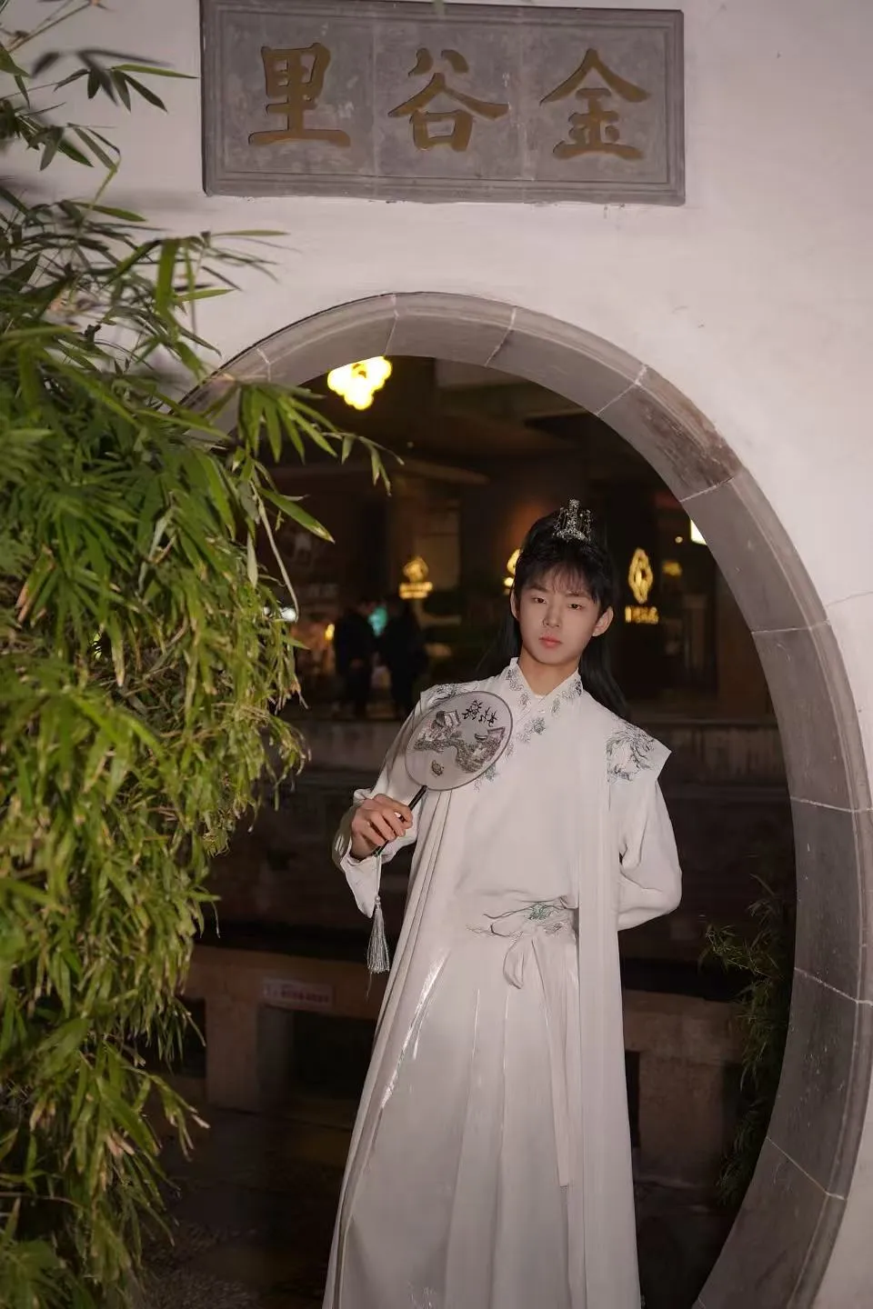 Noah wearing traditional Chinese clothing in a moon gate setting